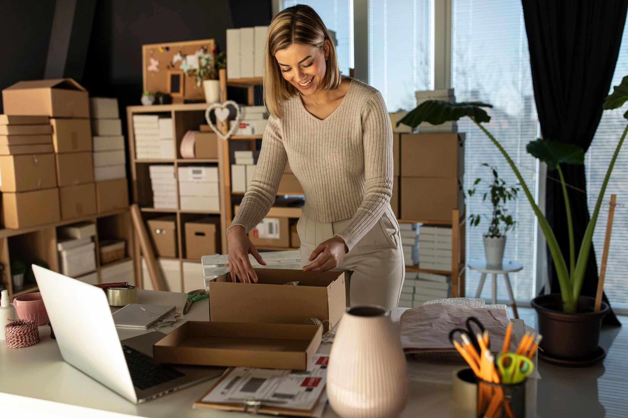 Small business owner packing an online order in a shipping box