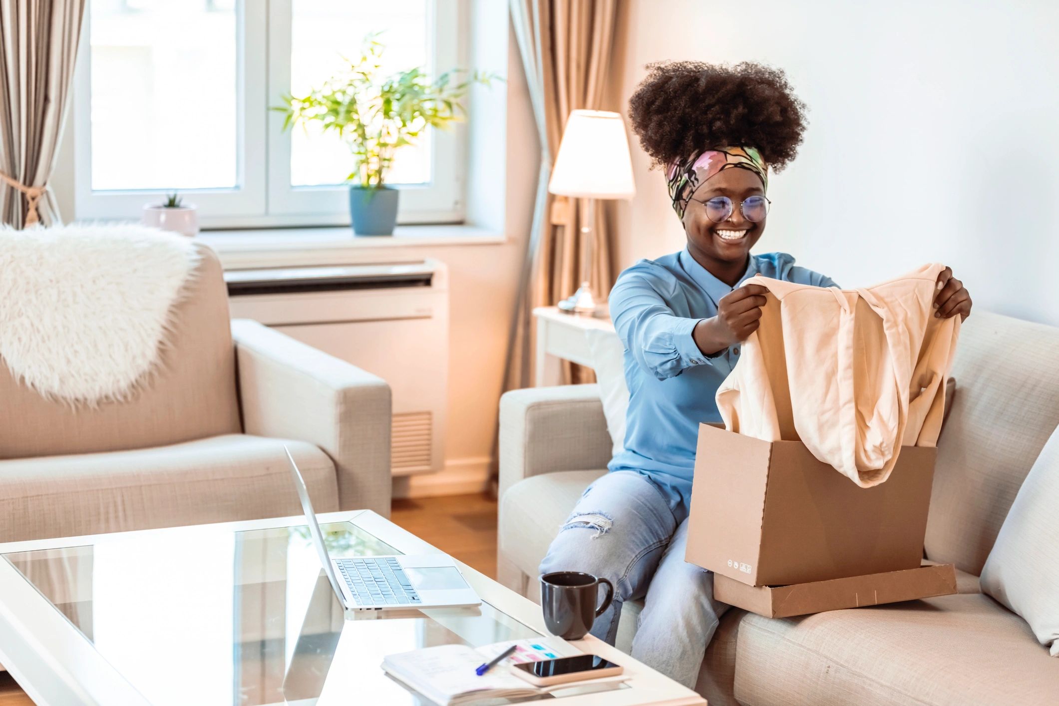 Happy customer opening a delivered package at home